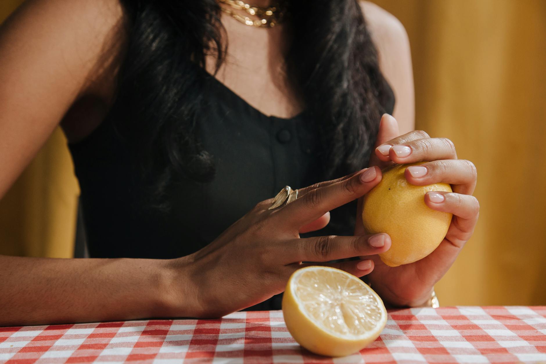 A close-up of a hand holding a vibrator against a minimalistic purple backdrop, showcasing sensuality and intimacy