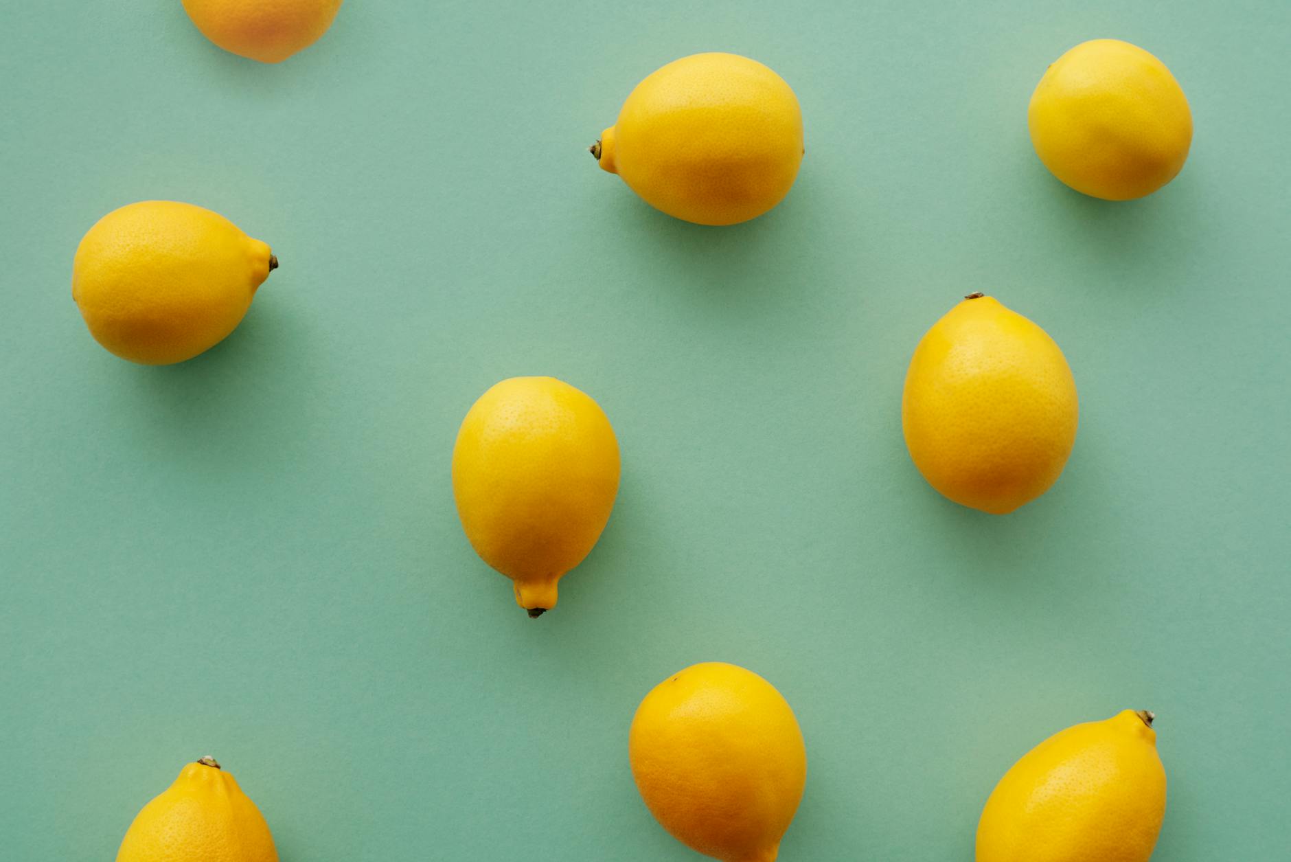 Bright yellow lemons arranged on pastel green background, symbolizing fresh starts and patient healing.